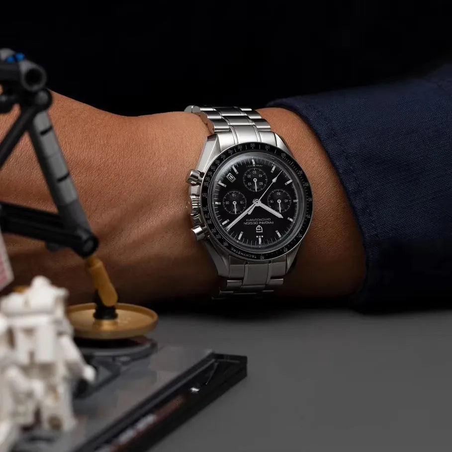 Pagani Design PD-1701 black dial chronograph watch on wrist with stainless steel bracelet Speedmaster homage style